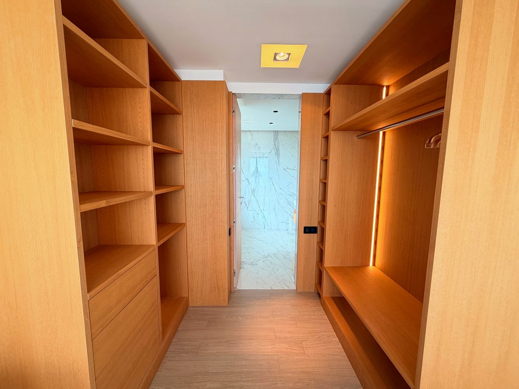 Walk-in dressing room with fitted shelving